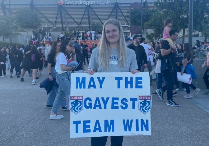 A Fan Shows The Poster Which Read 'may The Gayest Team Win'